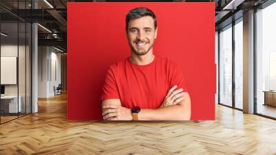 Handsome caucasian man wearing casual red tshirt happy face smiling with crossed arms looking at the camera. positive person. Wall mural