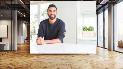 Handsome hispanic man wearing casual sweater at home with a happy and cool smile on face. Lucky person. Wall mural