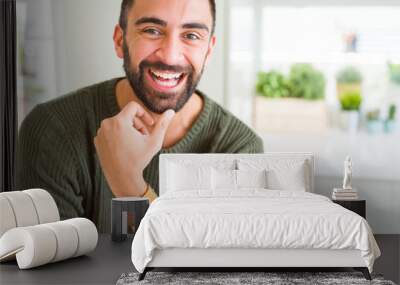 Handsome man smiling cheerful with a big smile on face showing teeth, positive and happy expression Wall mural