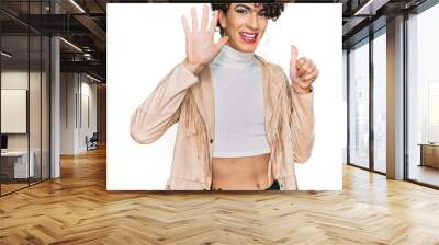 Handsome man wearing make up and woman clothes showing and pointing up with fingers number six while smiling confident and happy. Wall mural