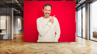 Handsome middle age senior man with grey hair over isolated red background cheerful with a smile on face pointing with hand and finger up to the side with happy and natural expression Wall mural