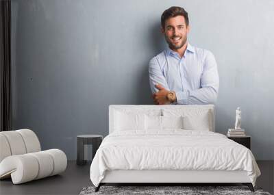 Handsome young business man over grey grunge wall wearing elegant shirt happy face smiling with crossed arms looking at the camera. Positive person. Wall mural