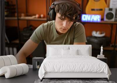 Handsome young hispanic teenager live at radio studio, seriously presenting news while lounging casually. dedicated reporter sweeps listeners off their feet with engaging mic speeches. Wall mural