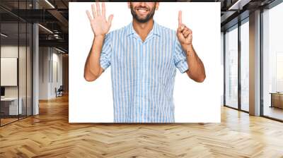 Handsome young man with beard wearing casual fresh shirt showing and pointing up with fingers number six while smiling confident and happy. Wall mural