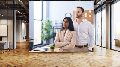 Man and woman business workers standing with arms crossed gesture at office Wall mural