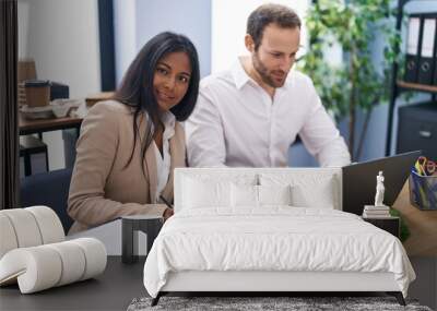 Man and woman business workers using laptop writing report at office Wall mural