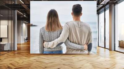 Man and woman couple hugging each other on back view at seaside Wall mural