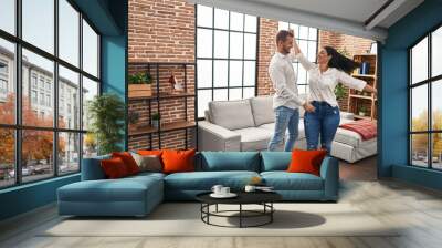 Man and woman couple smiling happy dancing at home Wall mural