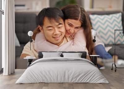 Man and woman couple using laptop hugging each other at home Wall mural