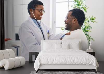 Man and woman doctor and patient having medical consultation auscultating chest at clinic Wall mural