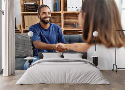 Man and woman having psychology session shake hands at psychology clinic Wall mural