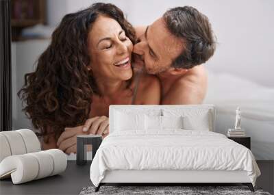 Man and woman smiling confident lying on bed kissing at bedroom Wall mural