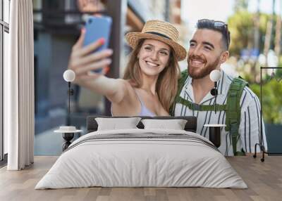 Man and woman tourist couple smiling confident make selfie by smartphone at street Wall mural