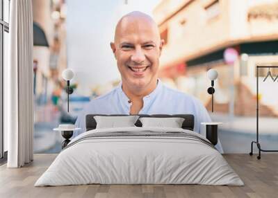 Middle age bald man smiling happy walking at the city. Wall mural