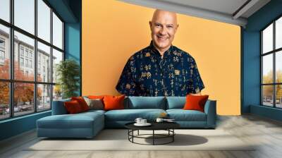 Middle age bald man wearing casual clothes looking positive and happy standing and smiling with a confident smile showing teeth Wall mural