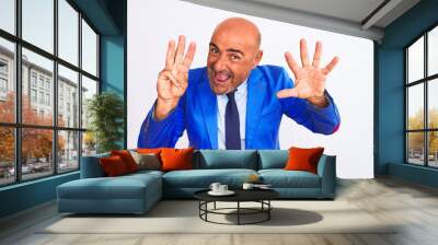 Middle age businessman wearing suit standing over isolated white background showing and pointing up with fingers number eight while smiling confident and happy. Wall mural