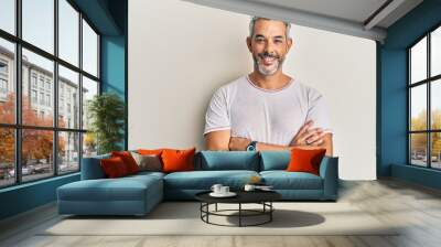 Middle age grey-haired man wearing casual clothes happy face smiling with crossed arms looking at the camera. positive person. Wall mural