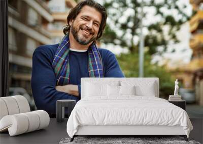 Middle age handsome man smiling with crossed arms at the town Wall mural