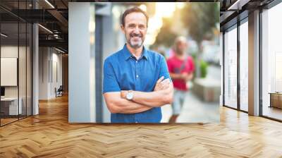 Middle age handsome man standing on the street smiling Wall mural