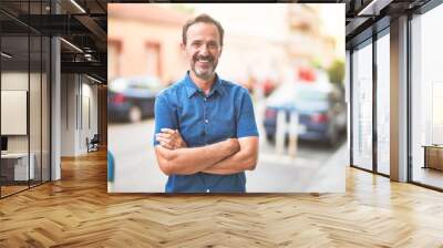 Middle age handsome man standing on the street smiling Wall mural