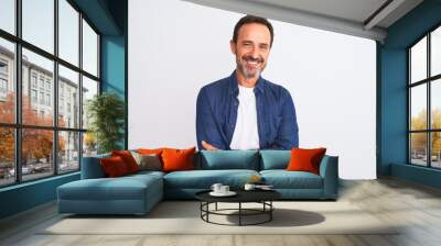 Middle age handsome man wearing blue denim shirt standing over isolated white background happy face smiling with crossed arms looking at the camera. Positive person. Wall mural