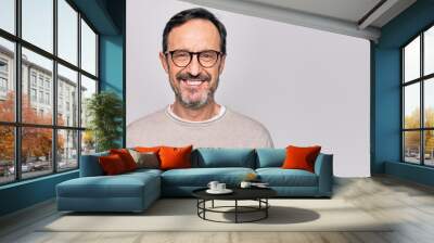 Middle age handsome man wearing casual sweater and glasses over isolated white background with a happy and cool smile on face. Lucky person. Wall mural