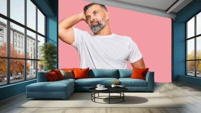 Middle age handsome man wearing casual white tshirt smiling confident touching hair with hand up gesture, posing attractive and fashionable Wall mural