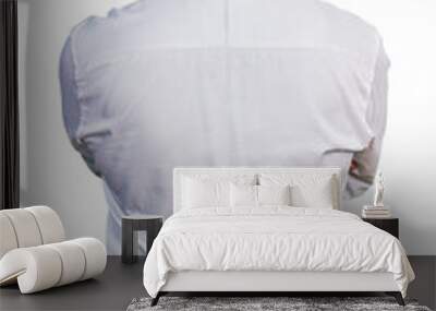 Middle age hispanic with grey hair wearing casual white shirt standing backwards looking away with crossed arms Wall mural