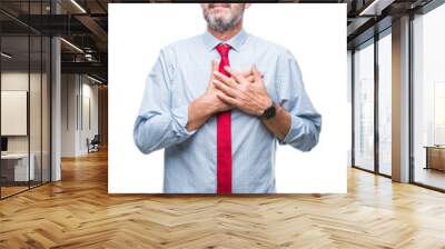 Middle age hoary senior business man wearing red tie over isolated background smiling with hands on chest with closed eyes and grateful gesture on face. Health concept. Wall mural