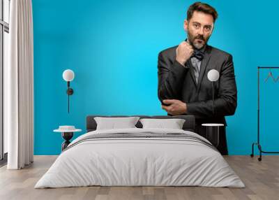 Middle age man, with beard and bow tie with crossed arms confident and serious Wall mural