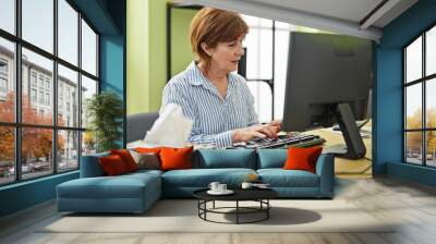 Middle age woman business worker using computer working at office Wall mural