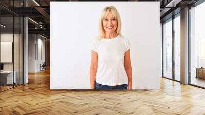 Middle age woman wearing casual t-shirt standing over isolated white background with a happy and cool smile on face. Lucky person. Wall mural