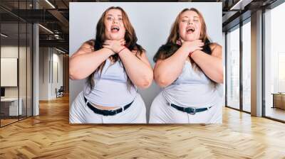 Plus size caucasian sisters woman wearing casual white clothes shouting and suffocate because painful strangle. health problem. asphyxiate and suicide concept. Wall mural