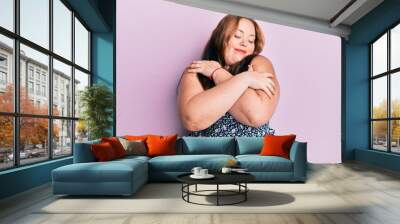 Plus size caucasian young woman wearing casual clothes hugging oneself happy and positive, smiling confident. self love and self care Wall mural