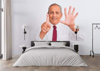 Senior grey-haired businessman wearing elegant tie over isolated white background showing and pointing up with fingers number six while smiling confident and happy. Wall mural