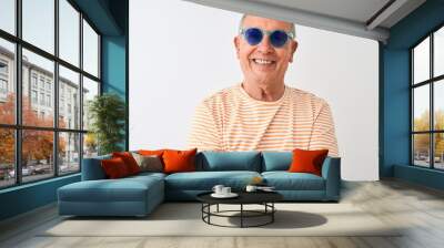 Senior grey-haired man wearing striped t-shirt and sunglasses over isolated white background happy face smiling with crossed arms looking at the camera. Positive person. Wall mural