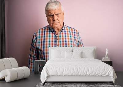 Senior handsome hoary man wearing casual colorful shirt over isolated pink background skeptic and nervous, frowning upset because of problem. Negative person. Wall mural