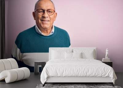 Senior handsome man wearing casual sweater and glasses over isolated pink background with a happy and cool smile on face. Lucky person. Wall mural