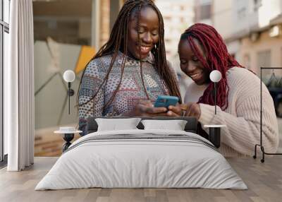 Two african american friends smiling confident using smartphone at street Wall mural