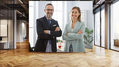 Two business workers standing together with arms crossed gesture at office Wall mural