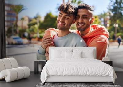 Two man couple hugging each other standing at street Wall mural