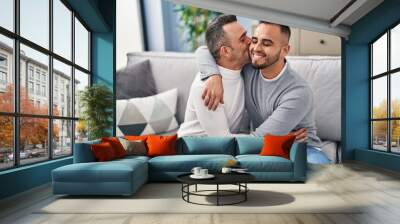 Two men couple hugging each other kissing at home Wall mural