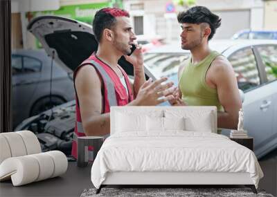 Two men talking on smartphone with insurance for car breakdown at street Wall mural