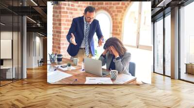 Two middle age business workers working together. Man bullying woman at the office Wall mural