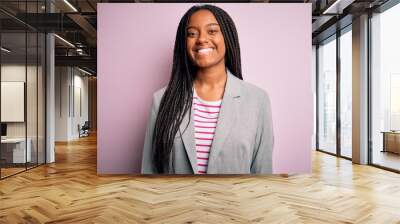 Young african american business woman standing over pink isolated background with a happy and cool smile on face. Lucky person. Wall mural