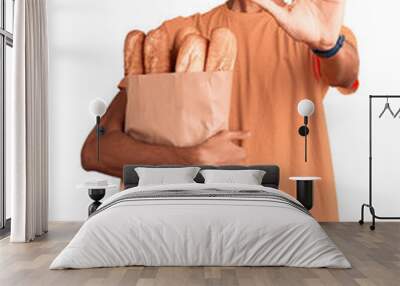 Young african american man holding paper bag with bread doing stop gesture with hands palms, angry and frustration expression Wall mural