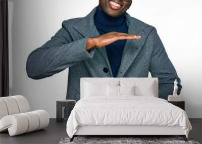 Young african american man wearing business clothes and glasses gesturing with hands showing big and large size sign, measure symbol. smiling looking at the camera. measuring concept. Wall mural