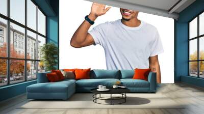 Young african american man wearing casual white t shirt waiving saying hello happy and smiling, friendly welcome gesture Wall mural