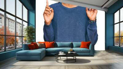 Young african american man wearing casual winter sweater pointing up looking sad and upset, indicating direction with fingers, unhappy and depressed. Wall mural