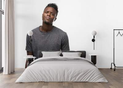 Young african american man wearing grey t-shirt skeptic and nervous, disapproving expression on face with crossed arms. Negative person. Wall mural